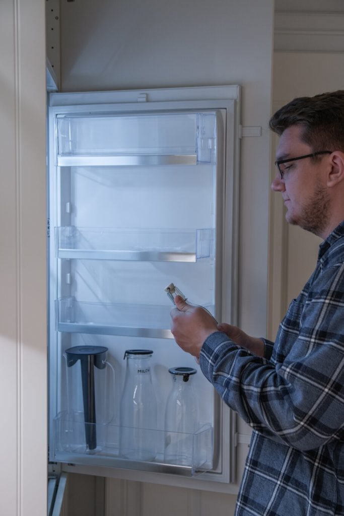 person using his refrigerator